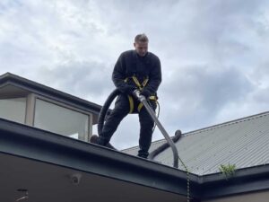 Man cleaning gutter